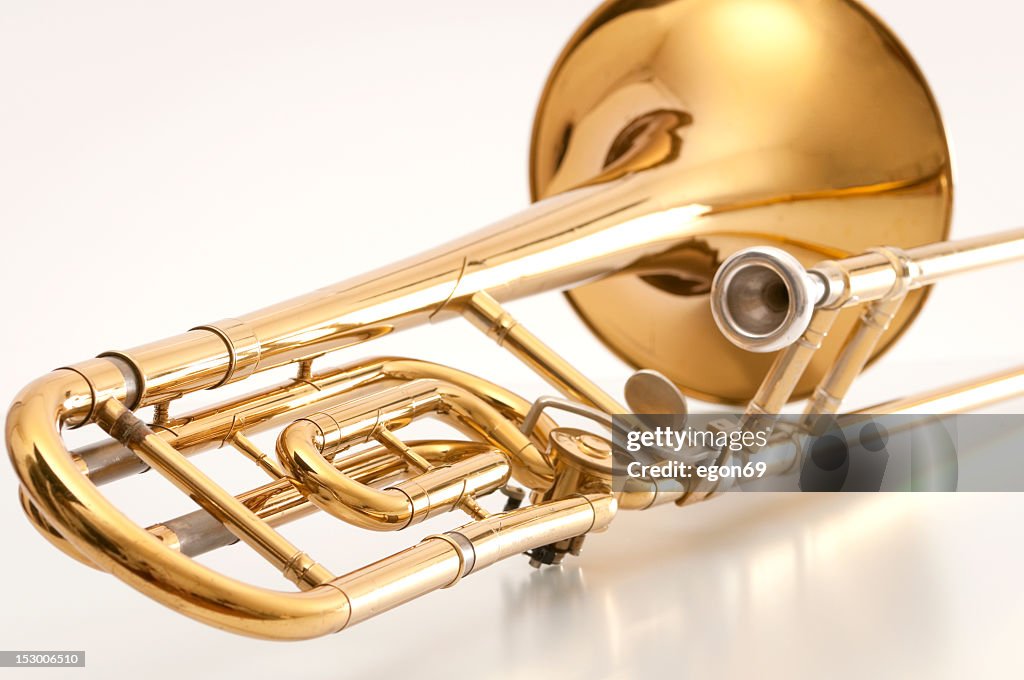 A closeup of the back of a golden trombone
