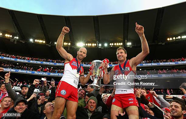 Jarrad McVeigh and Jude Bolton of the Swans celebrate with the Premiership Cup after winning the 2012 AFL Grand Final match between the Sydney Swans...