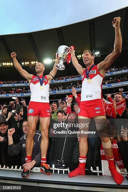 Jarrad McVeigh and Jude Bolton of the Swans celebrate with the Premiership Cup after winning the 2012 AFL Grand Final match between the Sydney Swans...