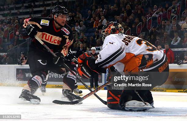 Andreas Morczinietz of Hannover fails to score over Daniar Dshunussow , goaltender of Wolfsburg during the DEL match between Hannover Scorpions and...