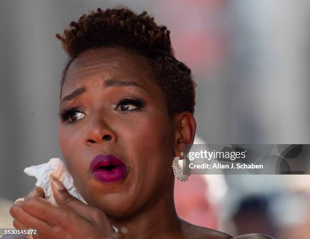 Hollywood, CA Amid a hot day, ESPN analyst Monica McNutt wipes perspiration from her face as she arrives on the red carpet at the 2023 ESPY Awards in...