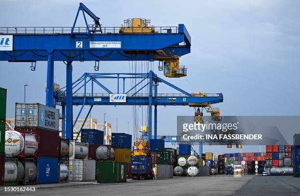 Containers are loaded with a container trolley at the seaport terminal DIT Duisburg Intermodal Terminal at the Duisburg harbour, on July 13, 2023....