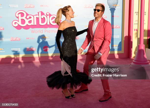 Margot Robbie and Scott Evans attend the World Premiere of "Barbie" at Shrine Auditorium and Expo Hall on July 09, 2023 in Los Angeles, California.