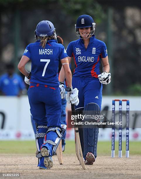Charlotte Edwards of England smiles towards Laura Marsh as they clock up the runs during the ICC Women's World Twenty20 2012 Group A match between...