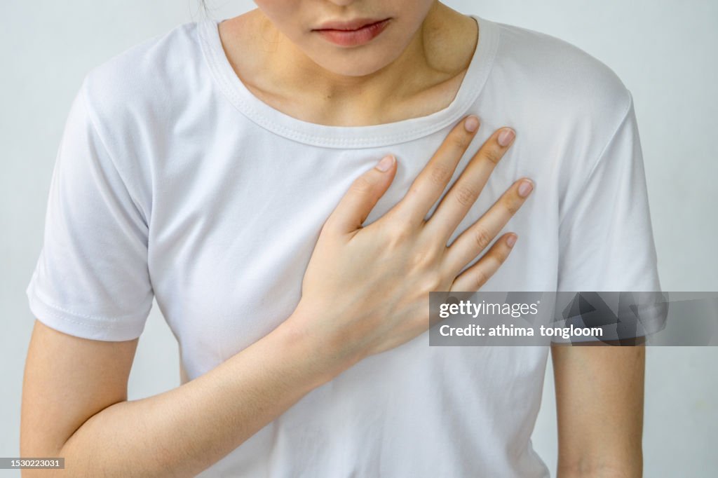 Mid section of woman with chest pain.