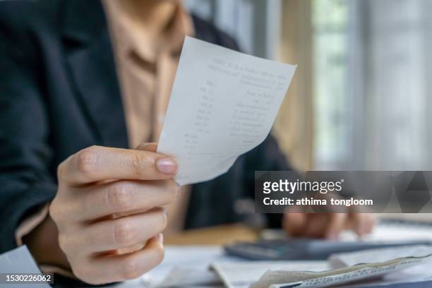 hand press on a calculator for counting monthly expenses. - high stock pictures, royalty-free photos & images