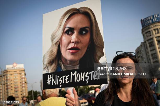 Protester hold a sign depicting Romanian Minister of the Family, Gabriela Firea reading "# Some Monsters" during a protest the ruling parties...