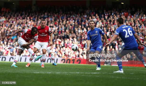 Arsenal's Gervinho scores their first goal of the match while Chelsea's John Terry defends during the Barclays Premier League match between Arsenal...