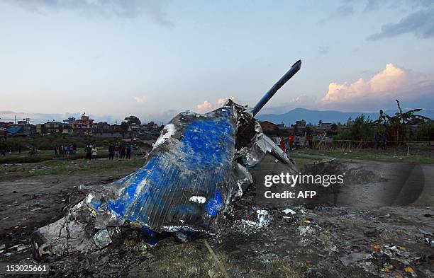 The mangled tail section of the crashed Sita Air Dornier Do 228 aircraft is seen in Manohara, Bhaktapur on the outskirts of Kathmandu on September...