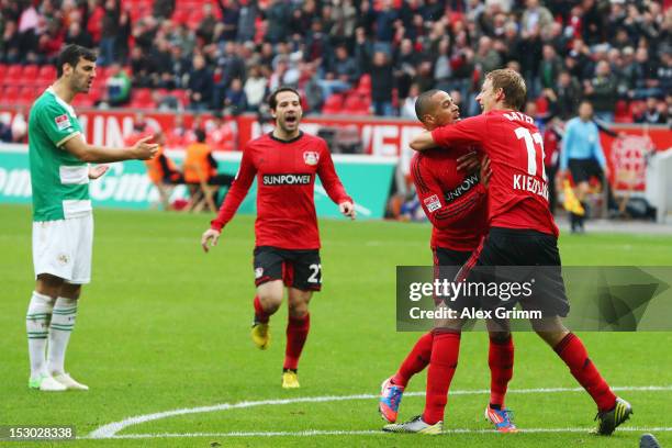 Sidney Sam of Leverkusen celebrates his team's first goal with team mates Stefan Kiessling and Gonzalo Castro during the Bundesliga match between...