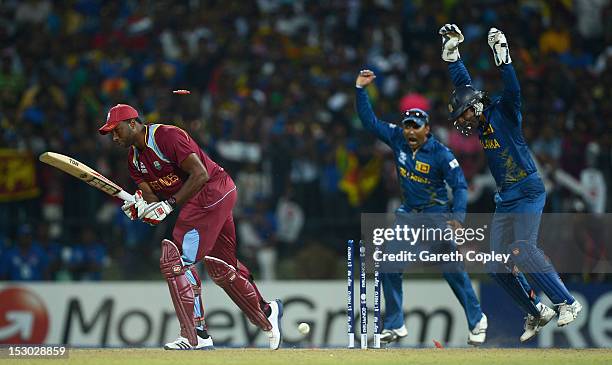 Mahela Jayawardene and Kumar Sangakkara of Sri Lanka celebrate after Kieron Pollard of the West Indies is bowled by Ajantha Mendis during the ICC...