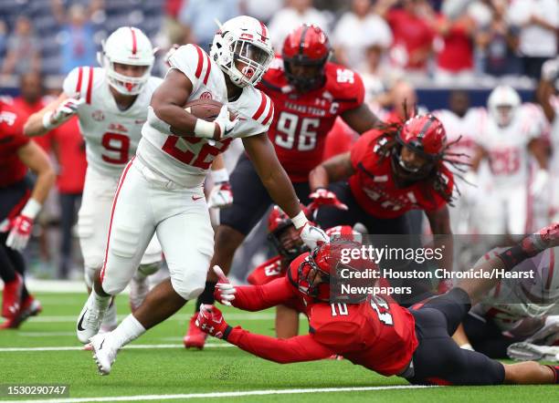 Mississippi Rebels running back Scottie Phillips stiff arms Texas Tech Red Raiders defensive back John Bonney on his way to a 39-yard rushing...