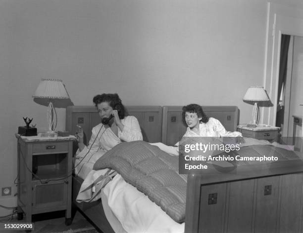 Two American young women calling the room service in Lausanne, 4th January 1949.