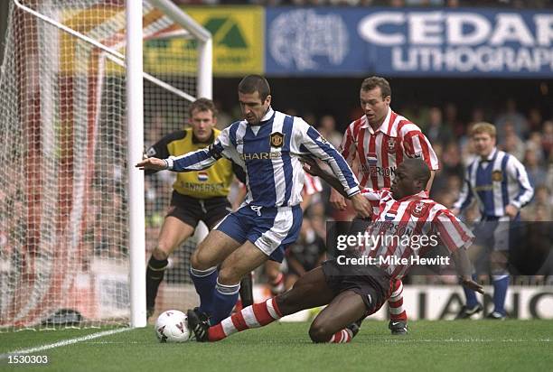 Eric Cantona of Manchester United scrambles for the ball with Ulrich Van Gobbel of Southampton during the FA Carling Premier league match between...