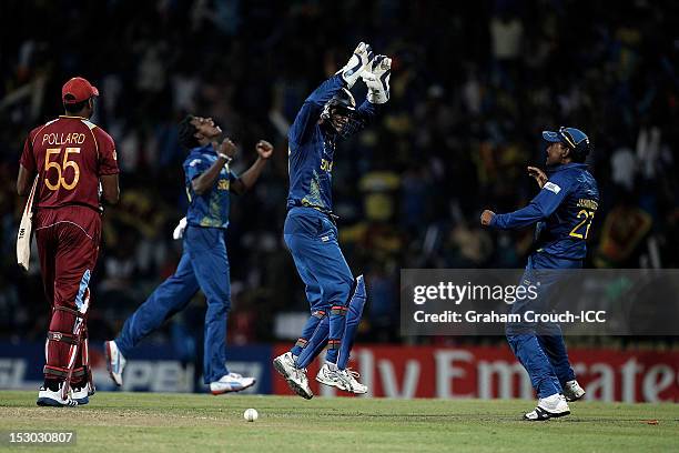 Kumar Sangakkara , Mahela Jayawardene and Ajantha Mendis of Sri Lanka celebrates the wicket of Kieron Pollard during the ICC World Twenty20 2012...
