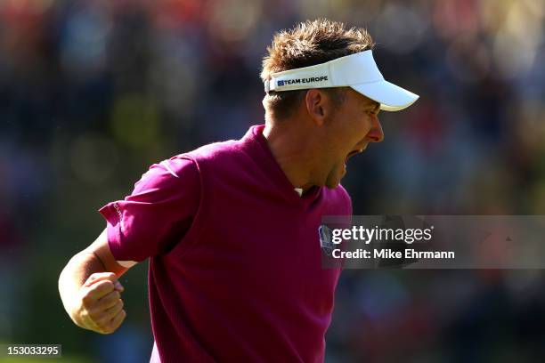 Ian Poulter of Europe celebrates after holing a putt on the 12th hole during day two of the Morning Foursome Matches for The 39th Ryder Cup at...
