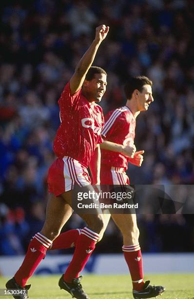 John Barnes of Liverpool and teammate Ian Rush acknowledge the crowd after a goal in the derby match against Everton at Anfield in Liverpool....