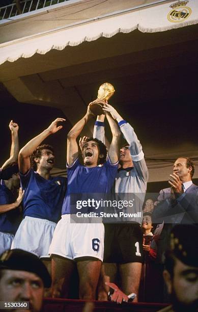 Gentile of Italy holds aloft the World Cup with team captain and goalkeeper Dino Zoff after Italy's victory over West Germany by 3-1 in the world cup...