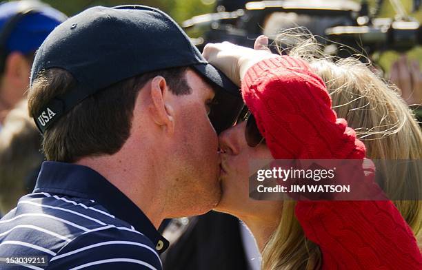 Keegan Bradley of the US gets a kiss from his girlfriend Jillian Stacey after The Morning Foursomes on the second day of play for The 39th Ryder Cup...