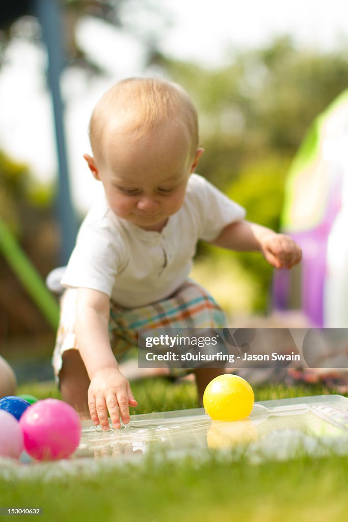 Small baby playing in garden