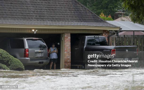 Woman looks at the flooded road in the Lochshire neighborhood Friday, Sept. 20 in Huffman, Texas. The Luce Bayou overflowed due to the heavy rain...