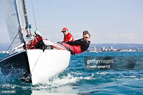 men enjoying the sport of sailing - competitive sailing stock pictures, royalty-free photos & images