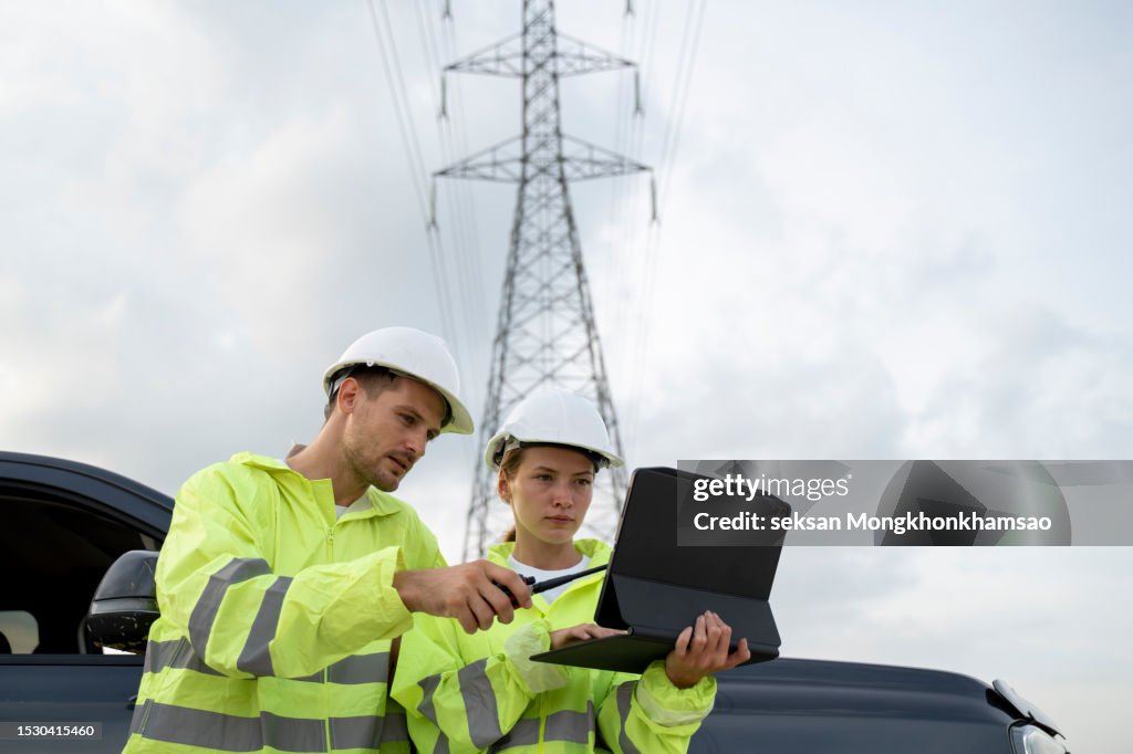High voltage engineers work on the field. Teamwork.