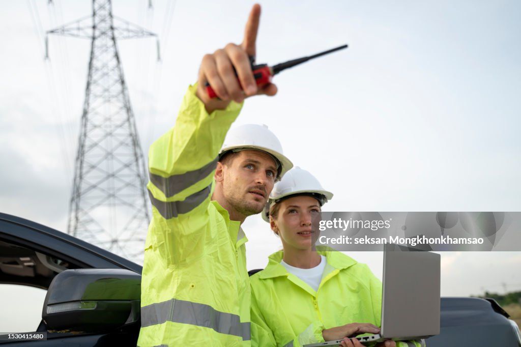 High voltage engineers work on the field. Teamwork.