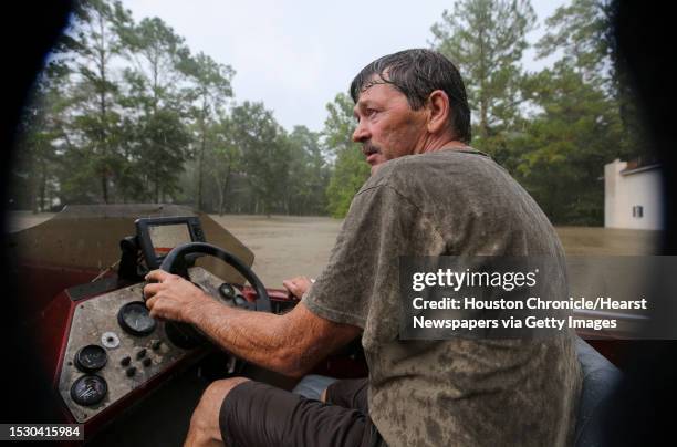 Mark Perkins drives his boat in the Lochshire neighborhood, looking for anyone wanting to evacuate their flooded homes Friday, Sept. 20 in Huffman,...