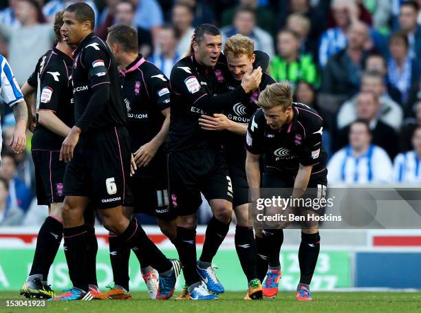 Chris Burke of Birmingham celebrates with team mates after scoring the opening goal of the game during the npower Championship match between Brighton...