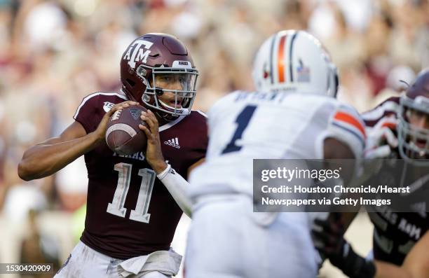 Texas A&M Aggies quarterback Kellen Mond looks for an open receiver against the Auburn Tigers during the third quarter of an SEC game at Kyle Field...