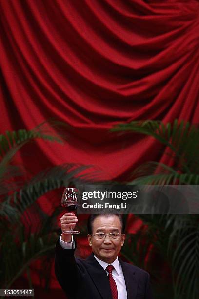 Chinese Prime Minister Wen Jiabao toasts the guests after delivering a speech during a banquet marking the 63th anniversary of the founding of the...