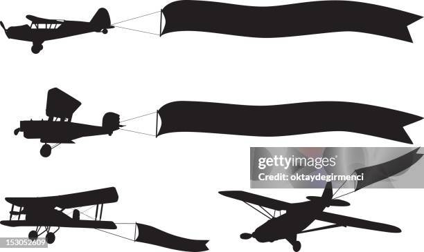 airplane silhoeutte banners - plane with banner stock illustrations