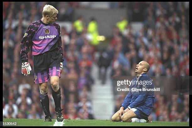 Peter Schmeichel of Manchester United looks at Gianluca Vialli of Chelsea, on his knees, during the FA Carling Premier league match between...