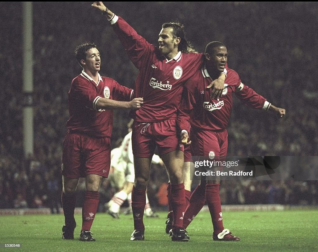 Robbie Fowlre and Patrik Bergr celebrate with John Barnes