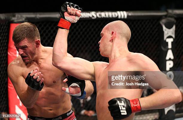 Strefan Struve punches Stipe Miocic during their heavyweight fight at the UFC on Fuel TV event at Capital FM Arena on September 29, 2012 in...