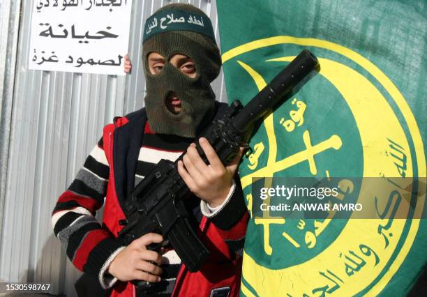 Lebanese child dressed as a militant attends a protest in front of the Egyptian embassy in Beirut on January 3, 2010 against a barrier Egypt is...