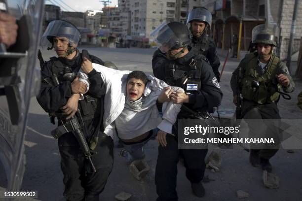 Palestinian youth is arrested by Israeli border policemen following clashes with Israeli forces at the Shuafat refugee camp in Jerusalem on February...