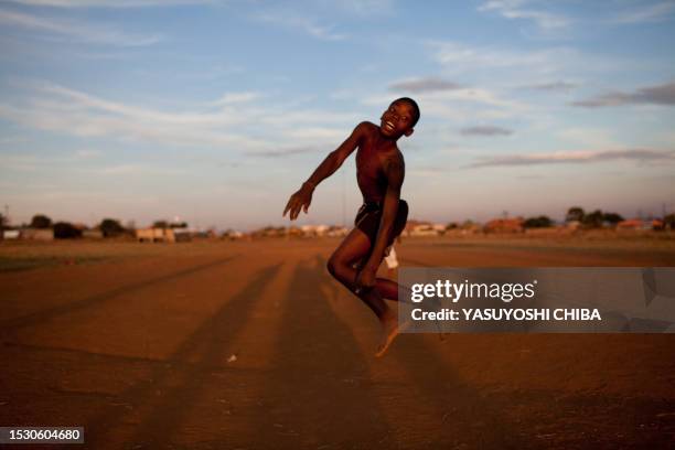 Boy plays football in a field in Soshanguve near Pretoria on June 22, 2009. South Africa is hosting the 2009 Fifa Confederations Cup from June 14 to...