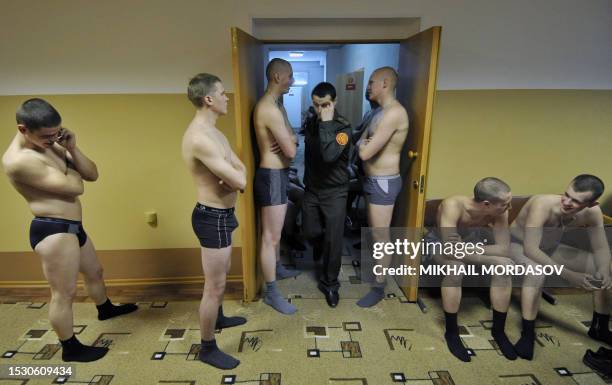 Russian teen boys stand in their underwear awaiting a medical check-up at the local army recruiting center in Veliky Novgorod on October 30, 2008 ....