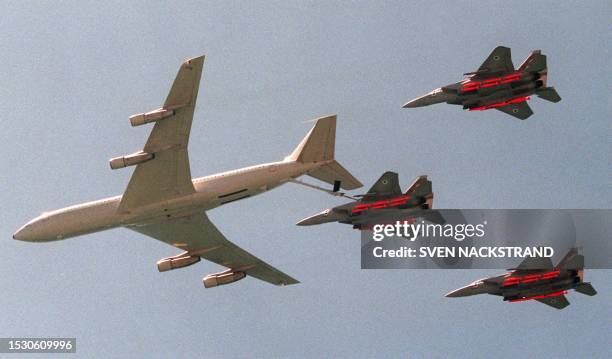 Israeli F-15 I jets are refuelled by a Boeing 707 in the air above a Tel Aviv beach, 30 April, where hundreds of thousands of people gathered to...