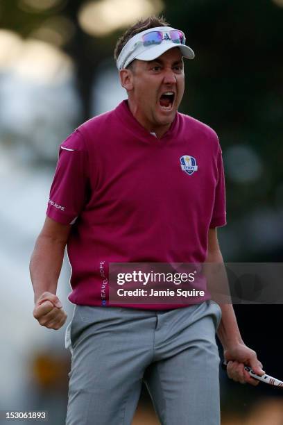 Ian Poulter of Europe celebrates after making birdie on the 18th green to help the Poulter/McIlroy team defeat the Dufner/Johnson team 1up during day...