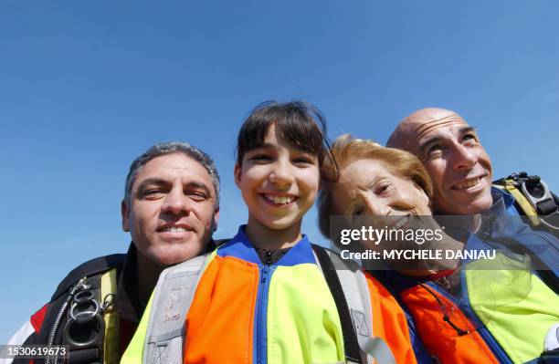 Ninety-five year old, French woman Blanche Olive and ten year old Pakistani-French teenager Oceane Malvy , pose with French paraglider pilots Mario...