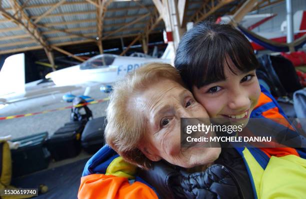 Ninety-five year old, French woman Blanche Olive and ten year old Pakistani-French teenager Oceane Malvy , pose after their jump, organized by the...