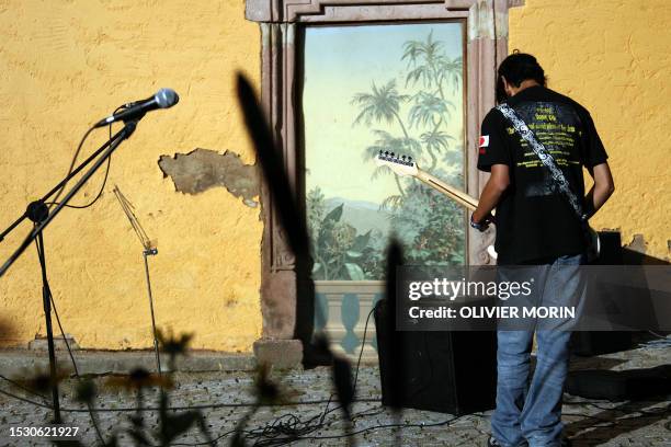 Young guitarist gets ready before performing in Barr, eastern France, 21 June 2007 during the music festival, the "Fete de la Musique". A million...