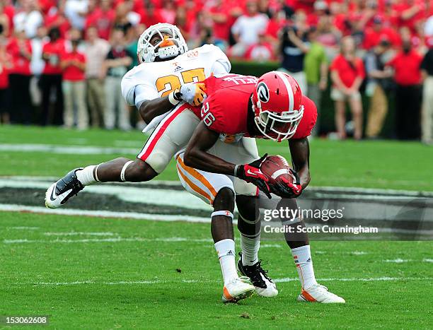 Malcolm Mitchell of the Georgia Bulldogs is tackled by Justin Coleman of the Tennessee Volunteers at Sanford Stadium on September 29, 2012 in Athens,...