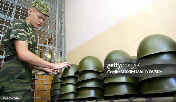 Member of a summer camp for difficult teenagers arranges helmets at their camp in a military unit in the town of Borisov, not far from Minsk 01...