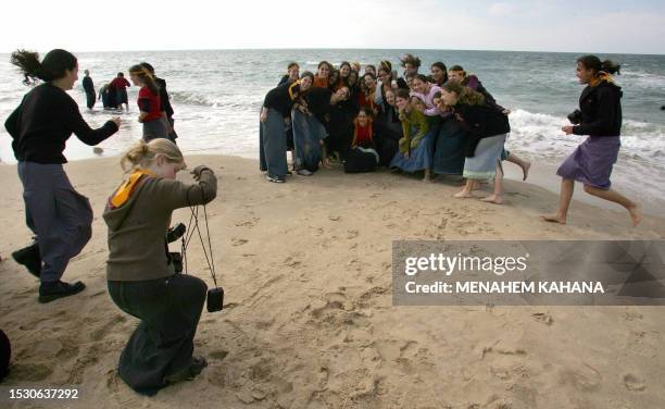 Israeli high school female students take a class photo along the beach in the Shirat Hayam settlement during a visit aimed at supporting the settlers...