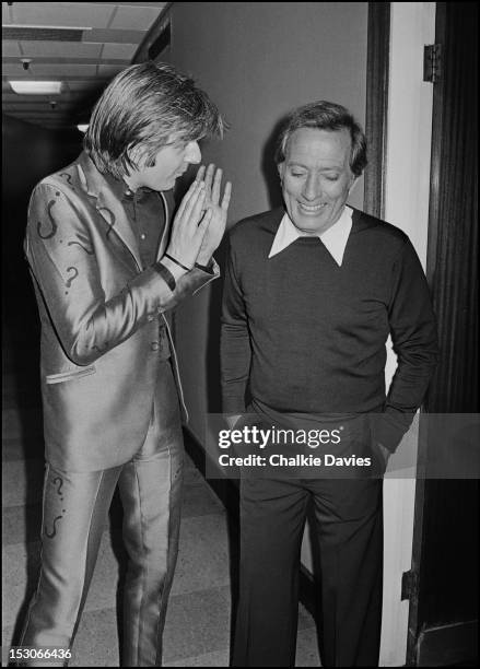 English singer-songwriter Nick Lowe with American singer Andy Williams , backstage at a recording of the BBC TV show 'Top Of The Pops', London, March...