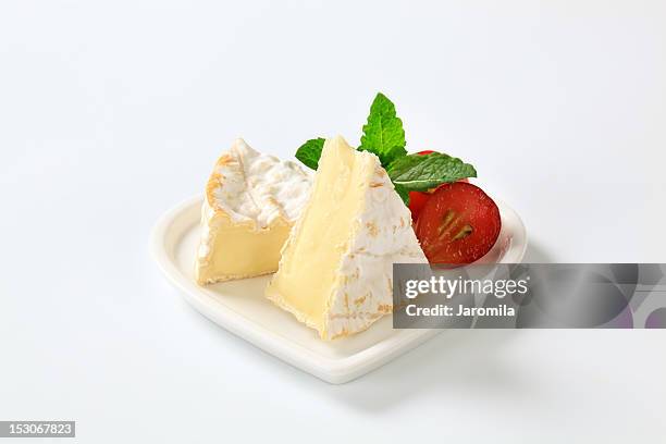 camembert cheese on a heart-shaped plate - brie stock pictures, royalty-free photos & images